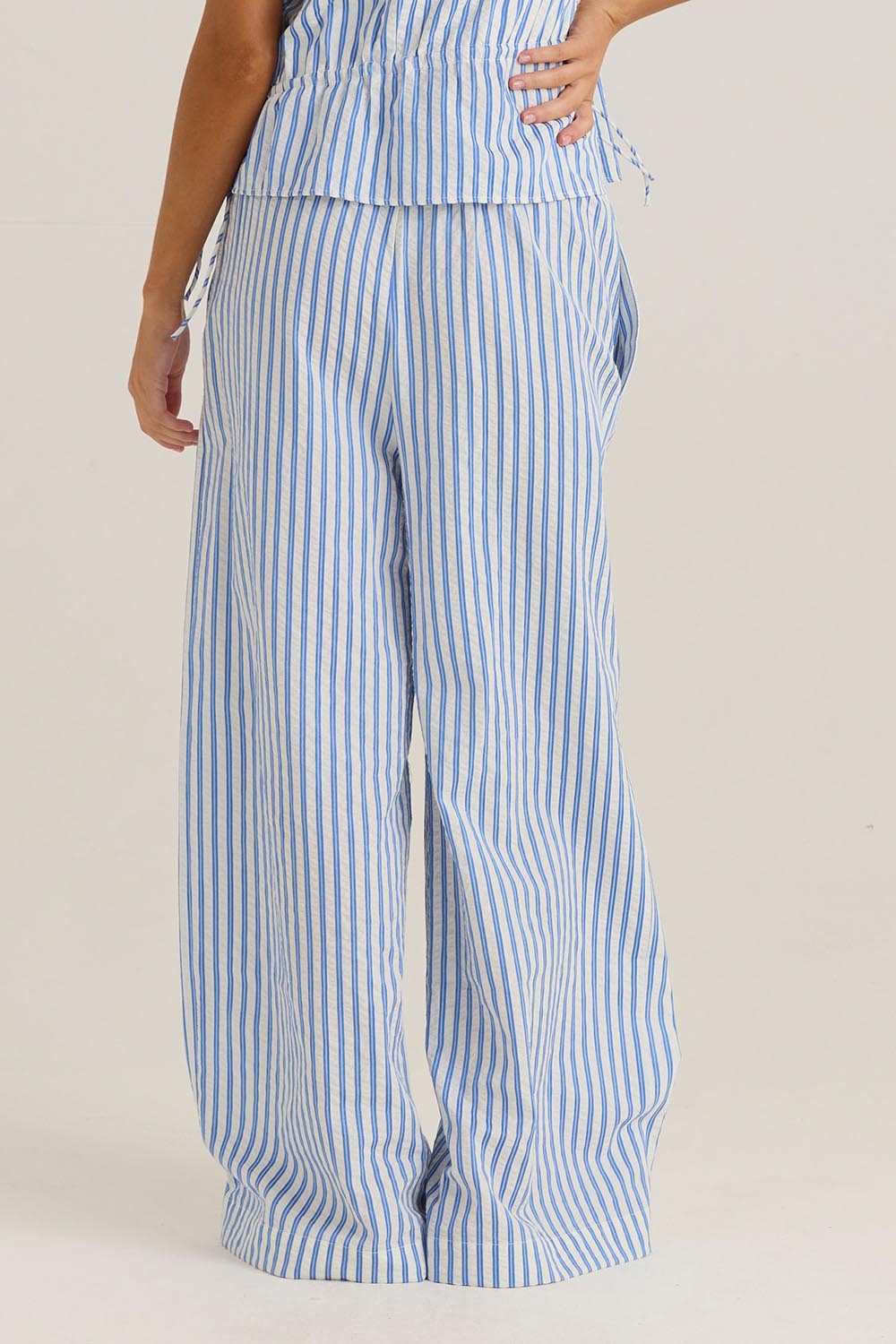 A model wearing the Aziza Pant in colour Bluewhite (Blue), from the back