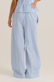 A model wearing the Aziza Pant in colour Bluewhite (Blue), from the back