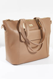 A model wearing size OneSize of the Charlie Baby/tote Bag in colour Taupe, from the front, showing the whole outfit