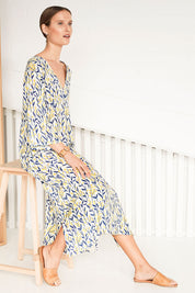 Model Johanna wearing size 10 of the Manstrale Midi Dress in colour Petals (White), from the front, showing the whole outfit