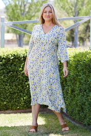 Model Ljubenka wearing size 18 of the Manstrale Midi Dress in colour Petals (White), from the front, showing the whole outfit