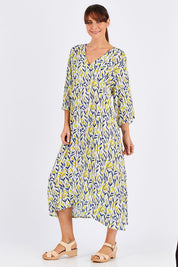 Model Monique wearing size 10 of the Manstrale Midi Dress in colour Petals (White), from the front, showing the whole outfit