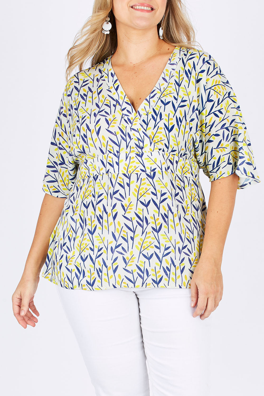 Model Ljubenka wearing size 18 of the Tystnad Blouse in colour YellowPtl, from the front, cropped image