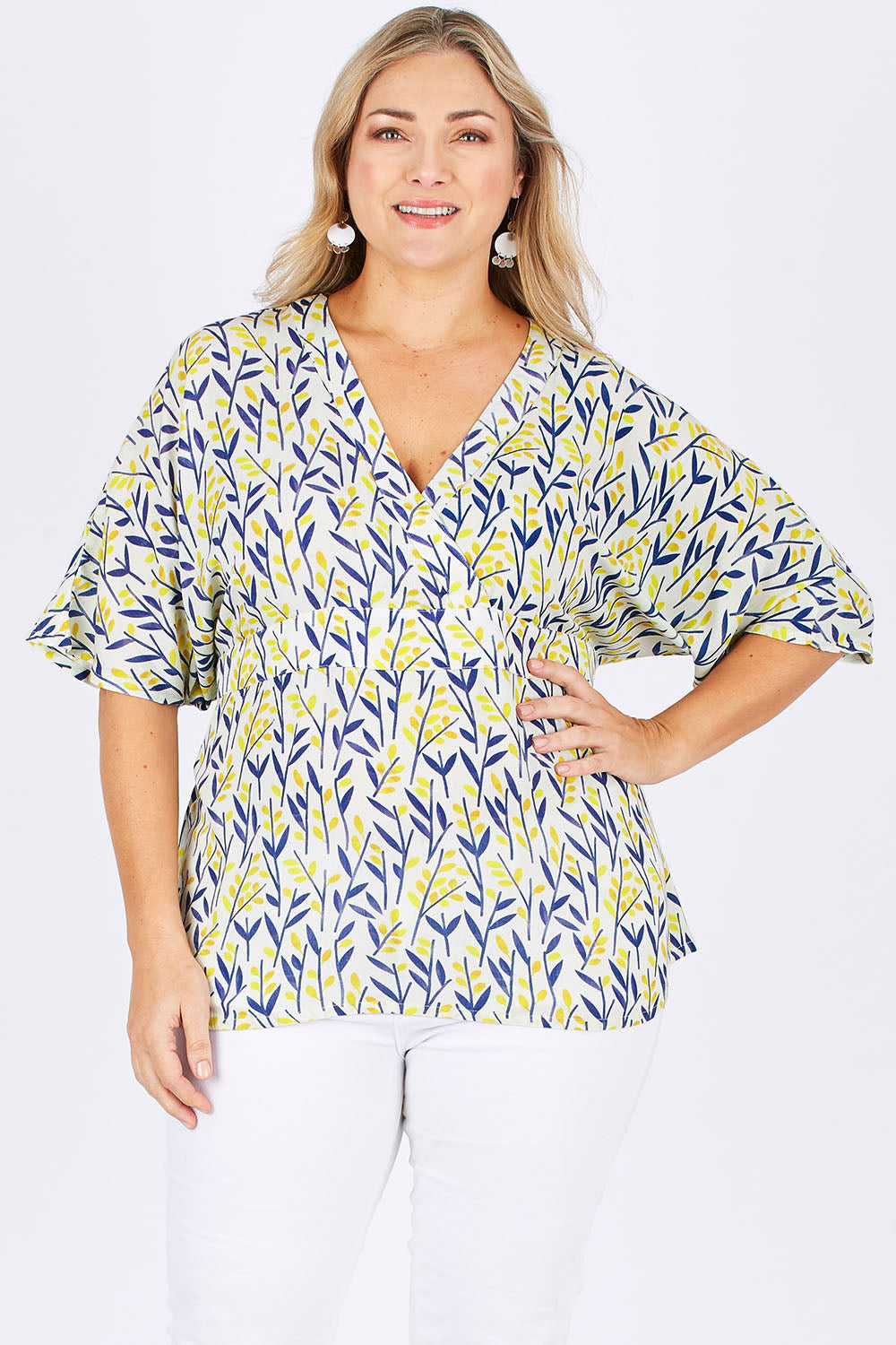 Model Ljubenka wearing size 18 of the Tystnad Blouse in colour YellowPtl, from the front, cropped image