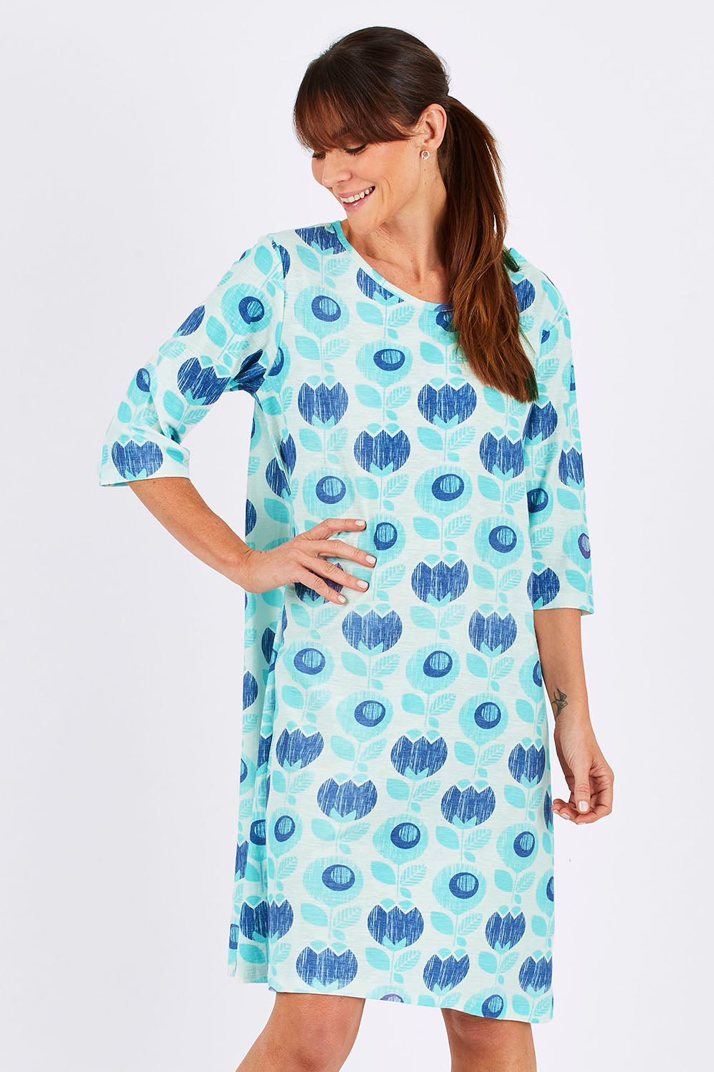 Model Monique wearing size 10 of the Vacker Dress in colour BlueFlower (Blue), from the front, cropped image