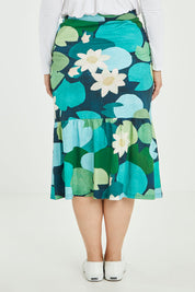 Model Jess wearing size 14 of the Insjo Skirt in colour Lilyblue (Blue), from the back