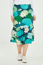 Model Jess wearing size 14 of the Insjo Skirt in colour Lilyblue (Blue), from the front, cropped image