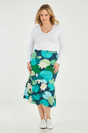 Model Jess wearing size 14 of the Insjo Skirt in colour Lilyblue (Blue), from the front, showing the whole outfit