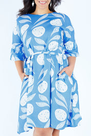 Model Lauren wearing size 16 of the Solnedgang Dress in colour Circflwr (Blue), from the front, cropped image