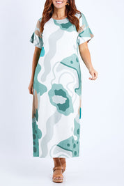 Model Laura wearing size 14 of the Helg Tee Dress in colour Lagoon (Blue), from the front, cropped image