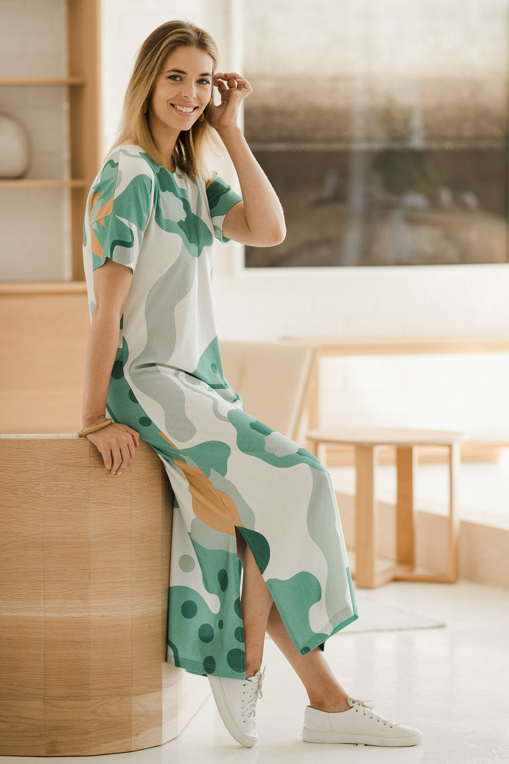 Model Phoebe wearing size 10 of the Helg Tee Dress in colour Lagoon (Blue), from the front, showing the whole outfit