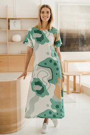 Model Phoebe wearing size 10 of the Helg Tee Dress in colour Lagoon (Blue), from the front, showing the whole outfit