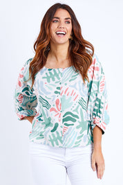Model Laura wearing size 14 of the Fyrkant Neck Blouse in colour Splatter (Green), from the front, cropped image