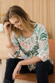 Model Phoebe wearing size 10 of the Fyrkant Neck Blouse in colour Splatter (Green), from the front, showing the whole outfit