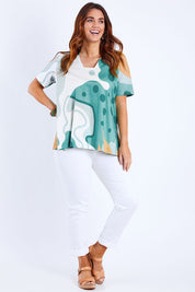 Model Laura wearing size 14 of the Avslappnad Top in colour Lagoon (Blue), from the front, showing the whole outfit