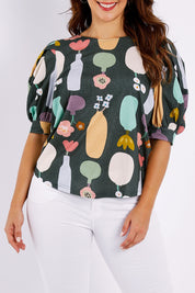 Model Jessica wearing size 14 of the Barnslig Puff Sleeve Tee in colour Pottery (Grey), from the front, cropped image