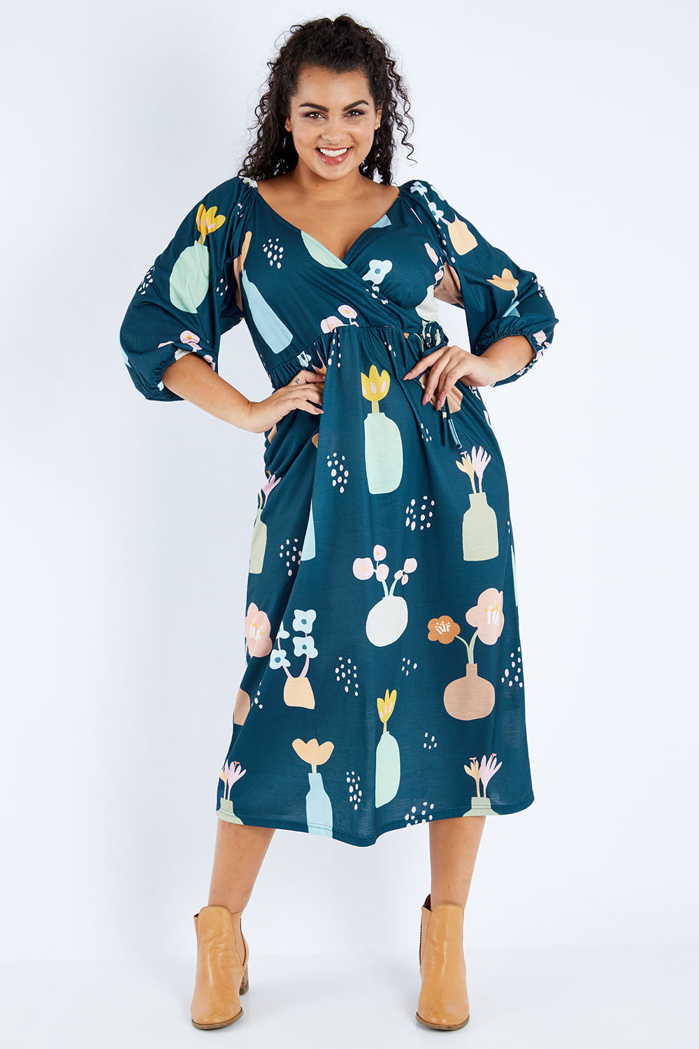 Model Sasha-Lee wearing size 16 of the Romantik Dress in colour Vases (Blue), from the front, showing the whole outfit