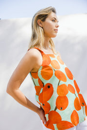 Model Phoebe wearing size 10 of the Undra Tank in colour Redberry (Red), from the front, showing the whole outfit
