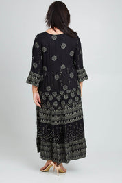 Model Poppy wearing size 16 of the Palm Beach Maxi Dress in colour Black (Black), from the back
