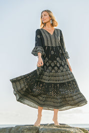 Model Riina wearing size 10 of the Palm Beach Maxi Dress in colour Black (Black), from the front, showing the whole outfit