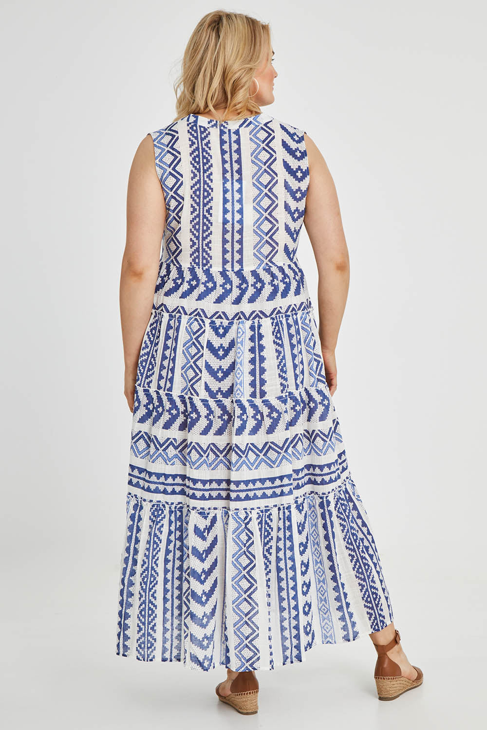 Model Keeara wearing size 16 of the Mollymook Cotton Maxi Dress in colour Blue (Blue), from the back
