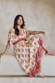 Model Tahneei wearing size 10 of the Pacific Beach Long Dress – Redcream in colour Redcream, from the front