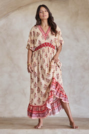 Model Tahneei wearing size 10 of the Pacific Beach Long Dress – Redcream in colour Redcream, from the front