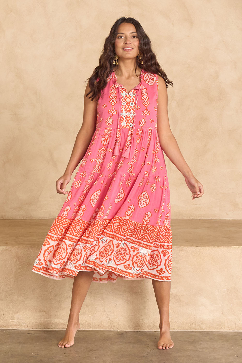 Model Tahnee wearing size 10 of the Jim Jim Falls Cotton Dress in colour Pinkorange (Pink), from the front, showing the whole outfit