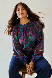 Model Tahnee wearing size 10 of the Finke Gorge Blouse in colour Paisley, from the front, cropped image