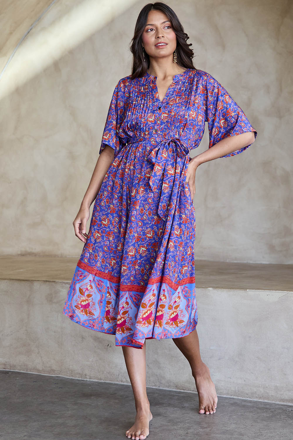 Model Tahneei wearing size 10 of the Turquoise Bay Dress – Rose in colour Rose, from the front