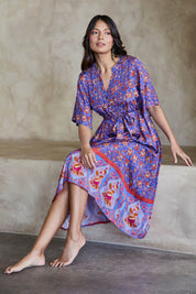 Model Tahneei wearing size 10 of the Turquoise Bay Dress – Rose in colour Rose, from the front