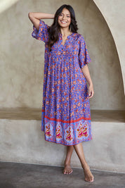 Model Tahneei wearing size 10 of the Turquoise Bay Dress – Rose in colour Rose, from the front