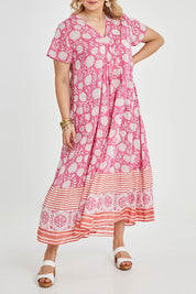 Model Keeara wearing size 16 of the Kurrawa Beach Long Cotton Dress in colour Pinkorange (Pink), from the front, cropped image