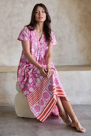 Model Tahneei wearing size 10 of the Kurrawa Beach Long Cotton Dress - Pinkorange in colour Pinkorange, from the front