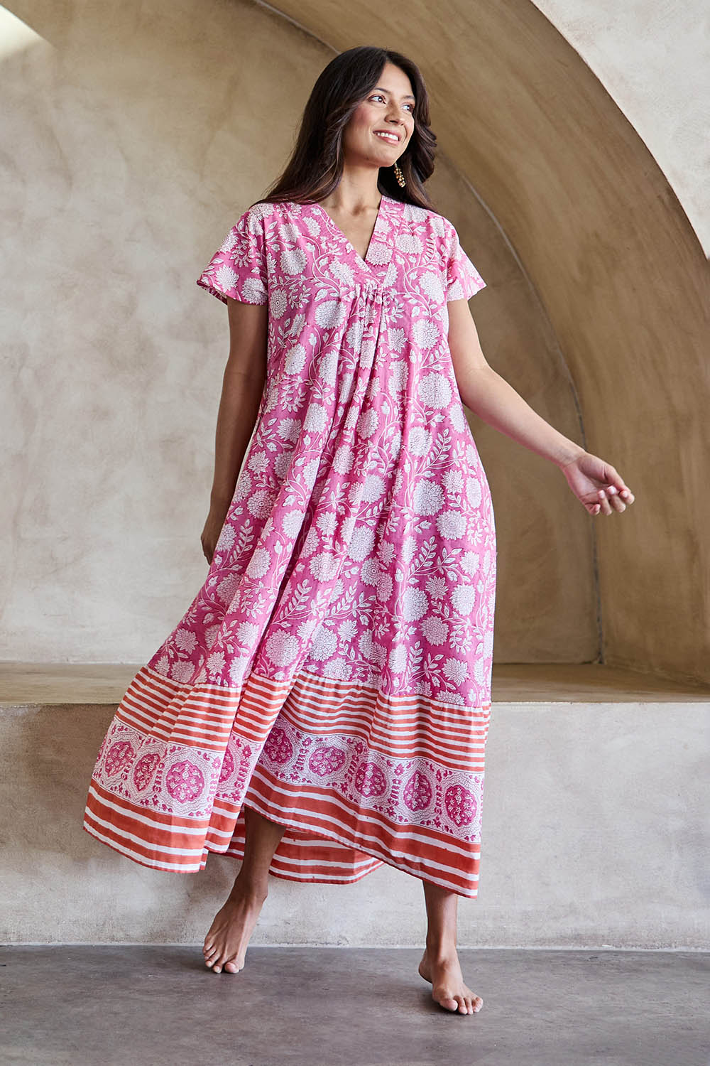 Model Tahneei wearing size 10 of the Kurrawa Beach Long Cotton Dress - Pinkorange in colour Pinkorange, from the front