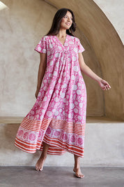 Model Tahneei wearing size 10 of the Kurrawa Beach Long Cotton Dress - Pinkorange in colour Pinkorange, from the front