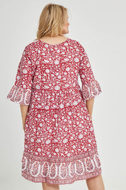 Model Keeara wearing size 16 of the Tallows Beach Cotton Dress in colour Red (Red), from the back