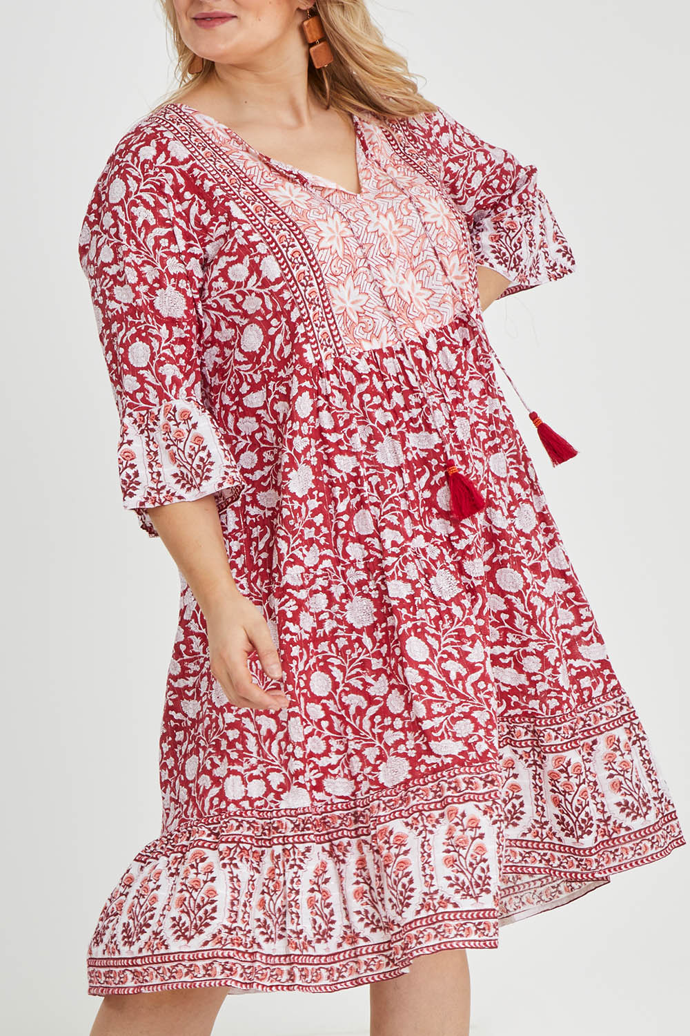 Model Keeara wearing size 16 of the Tallows Beach Cotton Dress in colour Red (Red), from the front, cropped image