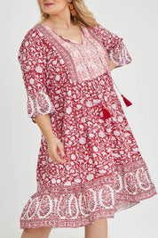 Model Keeara wearing size 16 of the Tallows Beach Cotton Dress in colour Red (Red), from the front, cropped image