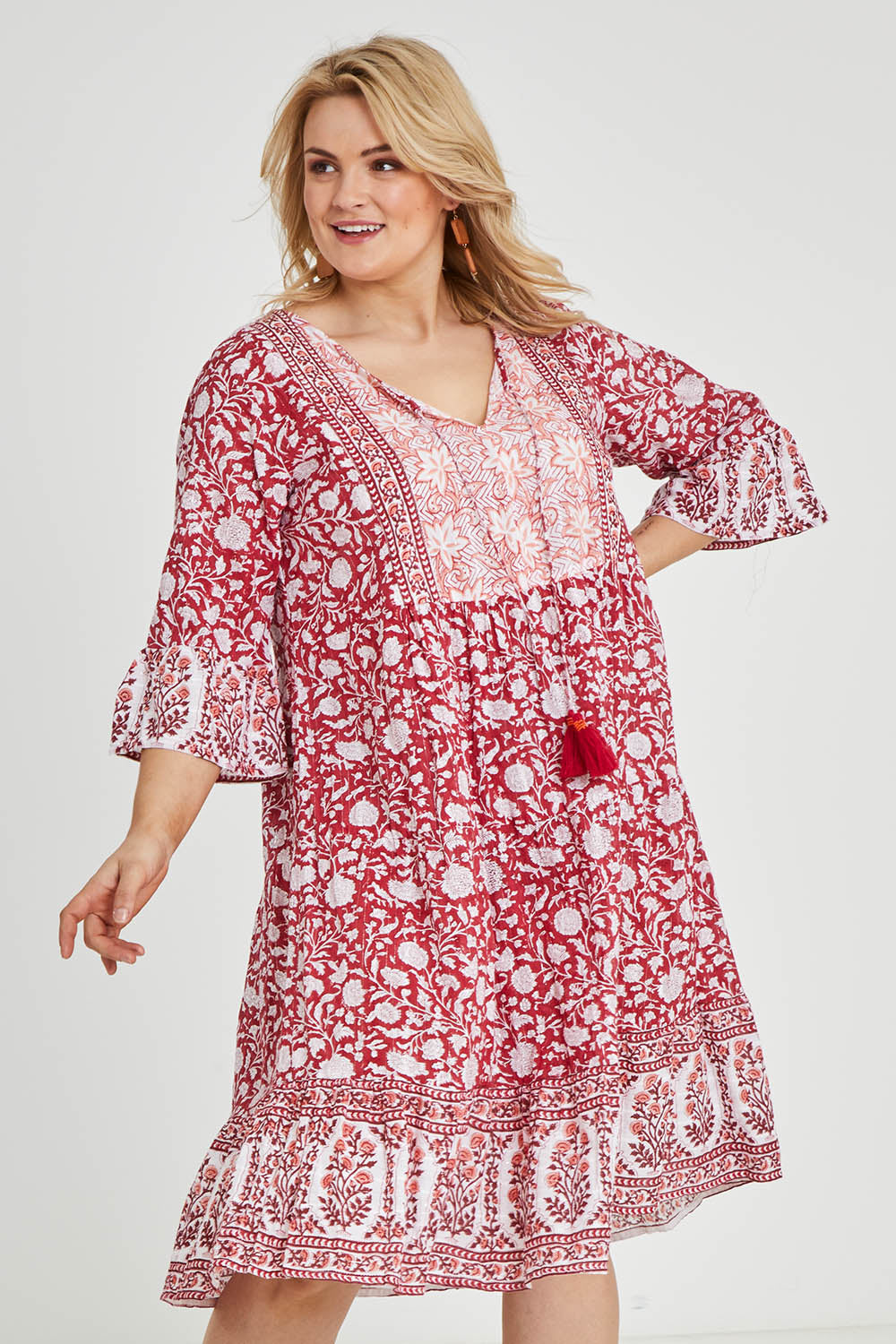 Model Keeara wearing size 16 of the Tallows Beach Cotton Dress in colour Red (Red), from the front, cropped image