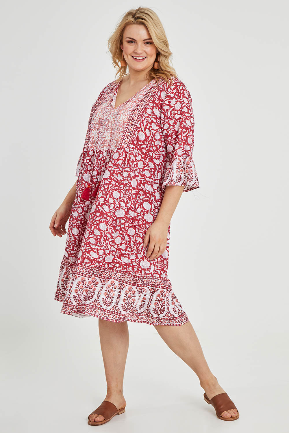 Model Keeara wearing size 16 of the Tallows Beach Cotton Dress in colour Red (Red), from the front, showing the whole outfit