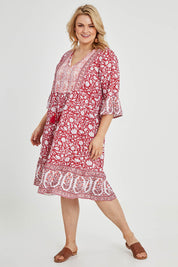 Model Keeara wearing size 16 of the Tallows Beach Cotton Dress in colour Red (Red), from the front, showing the whole outfit