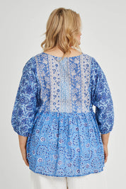 Model Keeara wearing size 16 of the Rosebud Beach Cotton Blouse in colour Blue (Blue), from the back