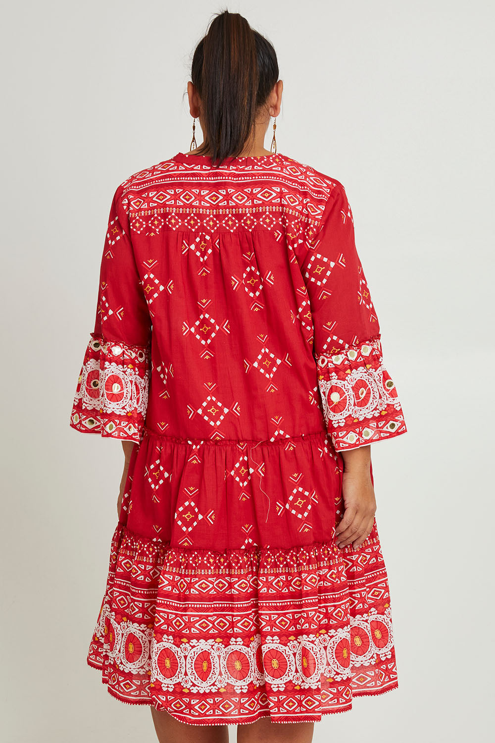 Model Ashleigh wearing size 16 of the Dee Why Beach Cotton Dress in colour Boldred (Red), from the back