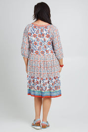 Model Poppy wearing size 16 of the Cocora Beach Dress in colour Bluered (Blue), from the back