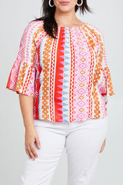 Model Poppy wearing size 16 of the Aslings Beach Cotton Blouse in colour Multipink (Pink), from the front, cropped image