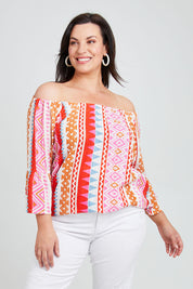 Model Poppy wearing size 16 of the Aslings Beach Cotton Blouse in colour Multipink (Pink), from the front, cropped image