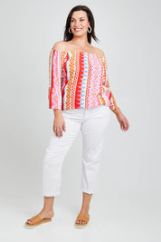 Model Poppy wearing size 16 of the Aslings Beach Cotton Blouse in colour Multipink (Pink), from the front, showing the whole outfit