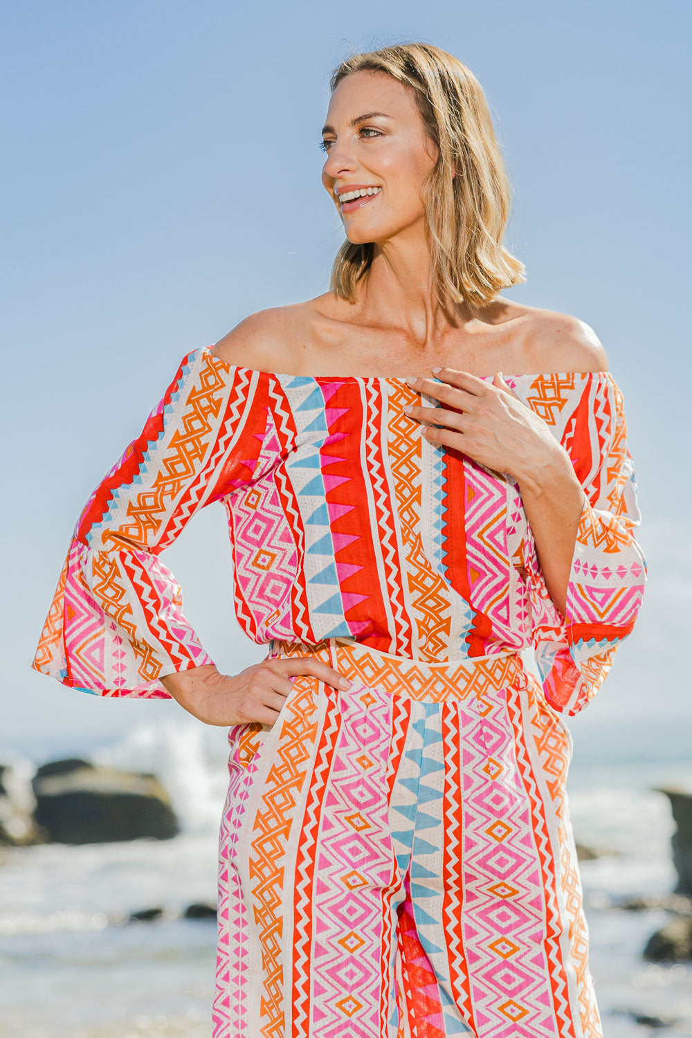 Model Riina wearing the Aslings Beach Cotton Blouse in colour Multipink (Pink), from the front, showing the whole outfit