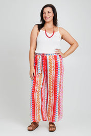 Model Poppy wearing size 16 of the Moon Bay Cotton Pants in colour Multipink (Pink), from the front, showing the whole outfit